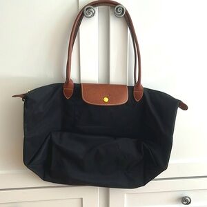 Barely used. Easily folds into itself. Great for travel. Large size tote